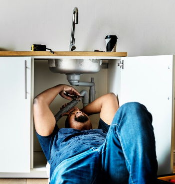 Plumber repairing pipe